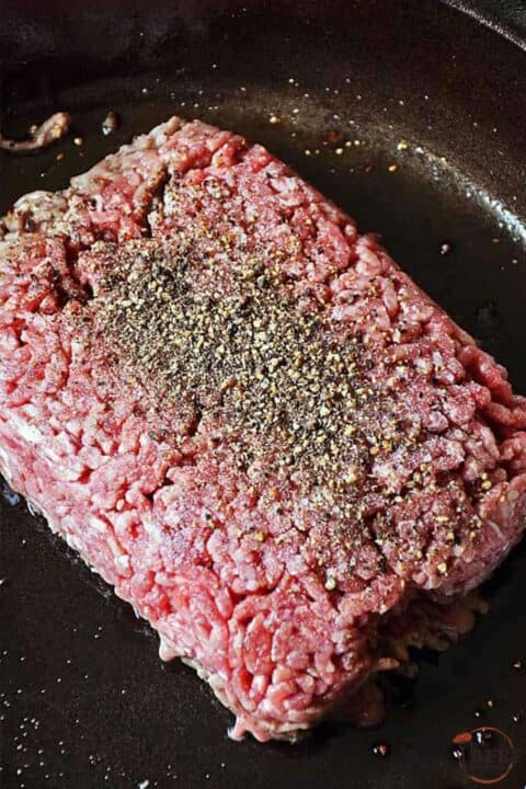 ground beef in a pan with seasoning