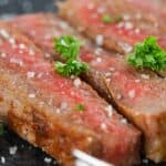 smoked wagyu steak sliced on a black plate