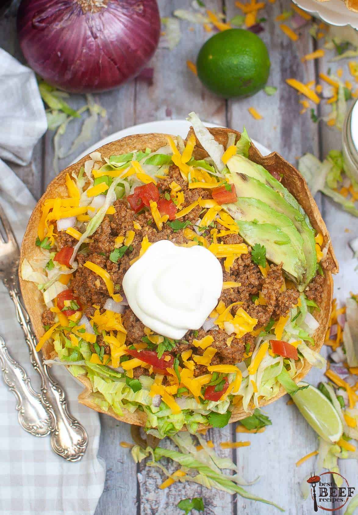 taco salad in a tortilla bowl on a white plate