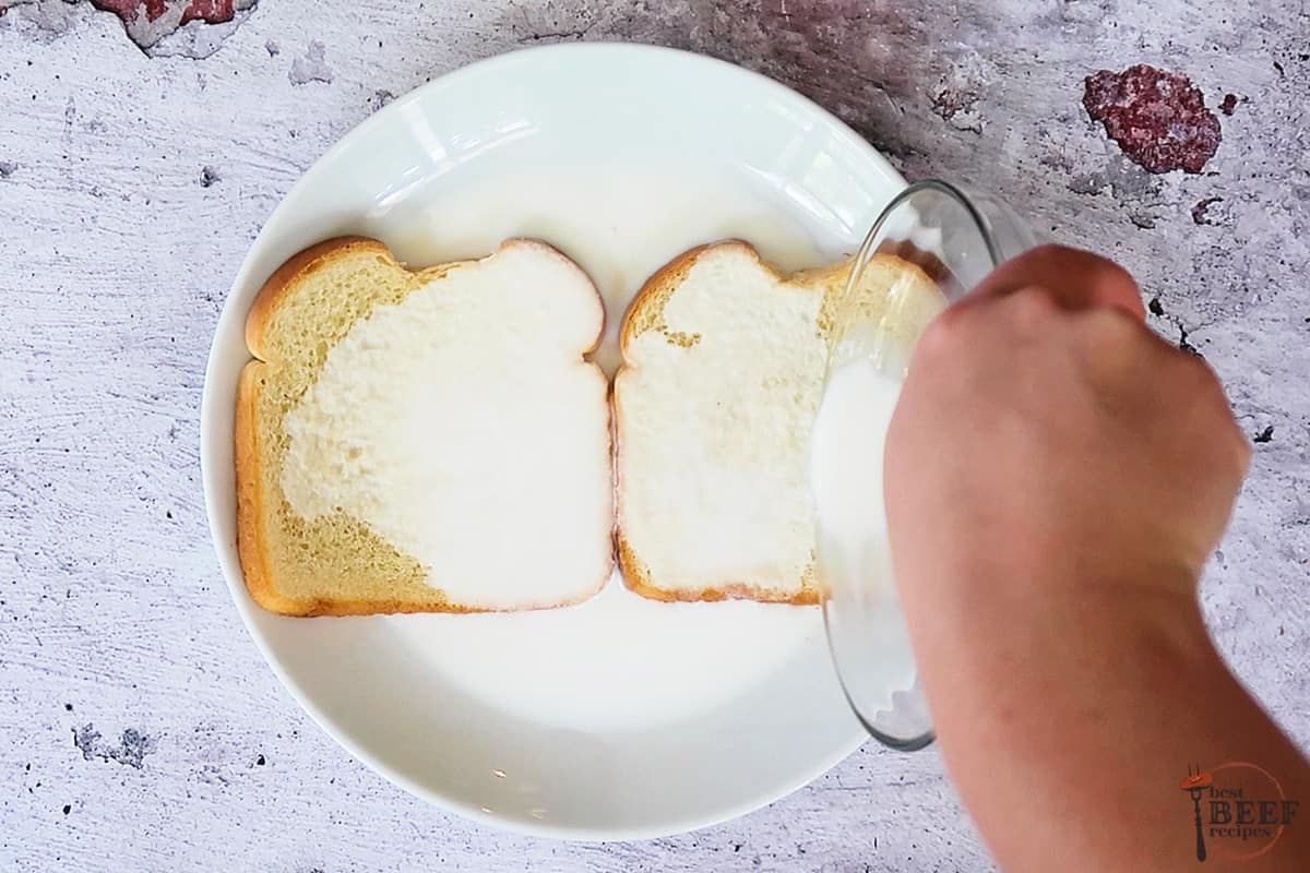 white bread on a white plate with milk pouring over top