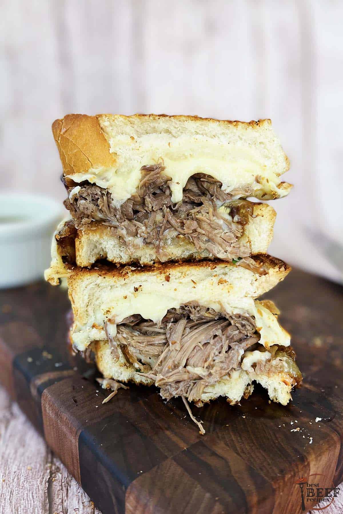 two pot roast sandwiches stacked on top of each other