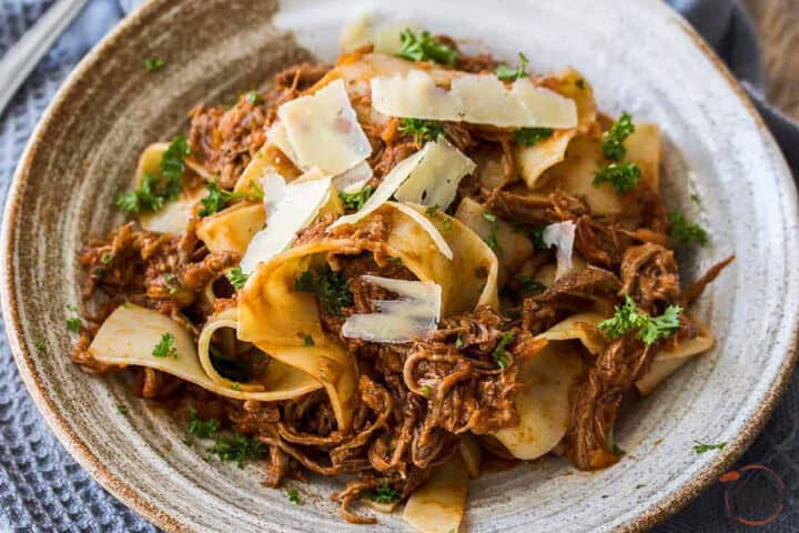 slow cooker beef ragu in a grey bowl