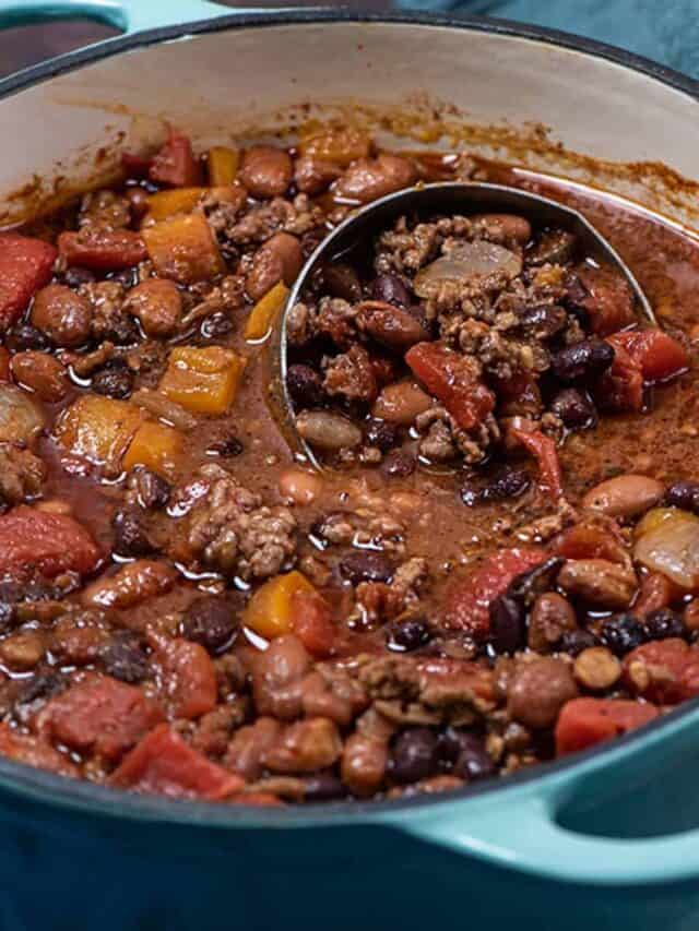 beef chili in a blue pot with a ladle