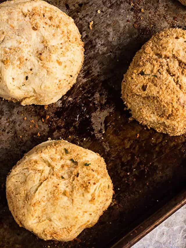 Three cooked papas rellenas on a baking sheet