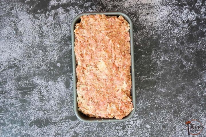 spreading italian meatloaf mix into baking dish