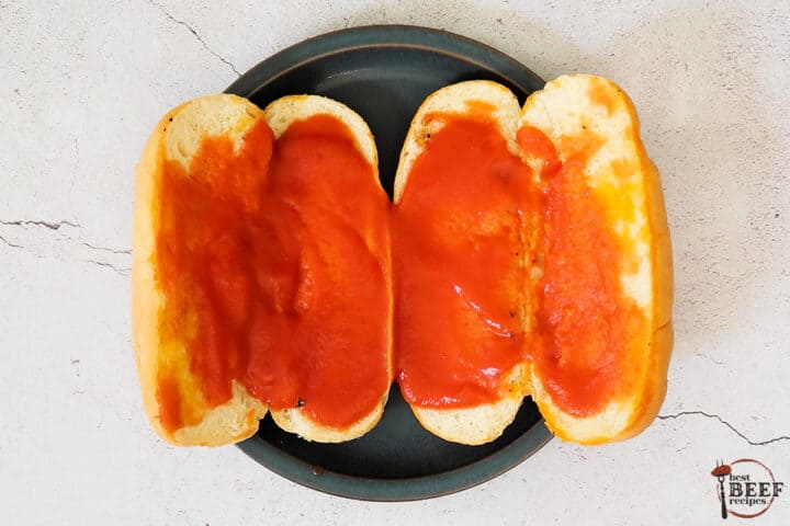 ketchup smeared on two buns for a meatloaf sandwich