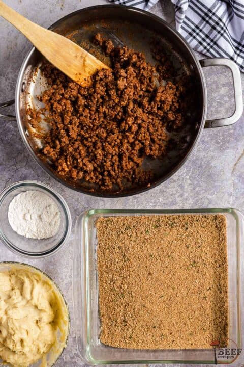 top view of containers with separated seasoned breadcrumbs, mashed potatoes, flour and seasoned ground beef