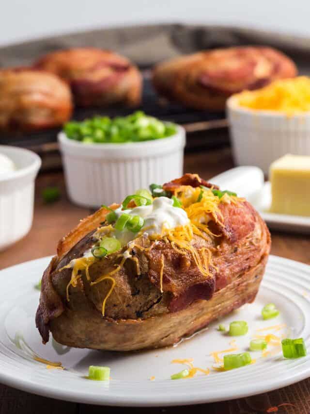 close up of a steakhouse baked potato on a plate