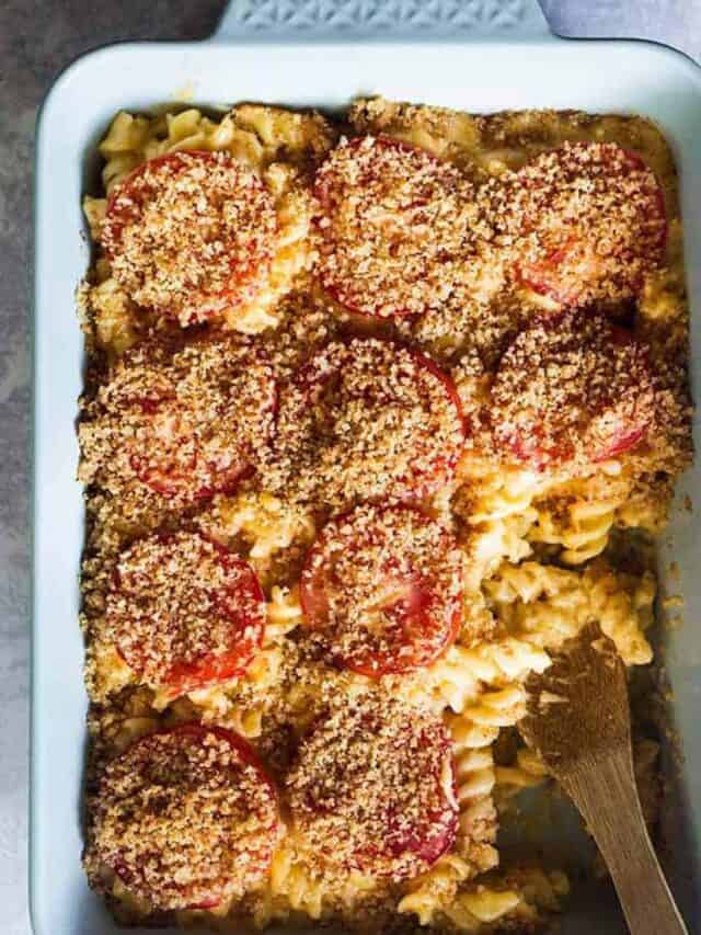 baked steakhouse mac and cheese with a wooden spoon inside