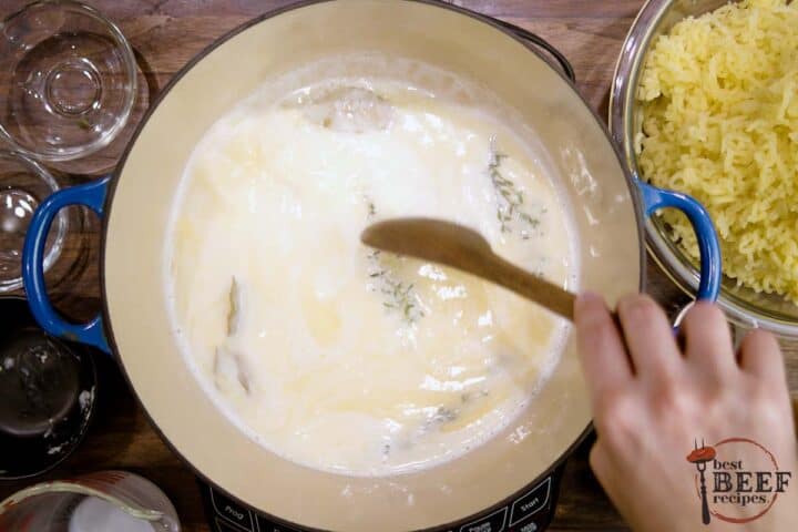 stirring melted butter and milk with herbs