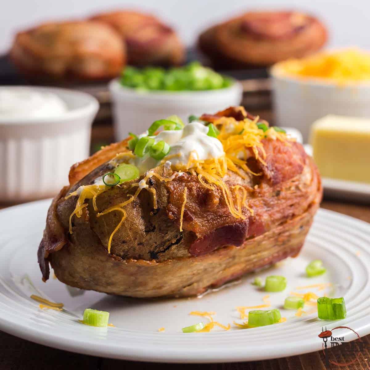 steakhouse baked potato wrapped in bacon and stuffed with sour cream, green onions, and cheese