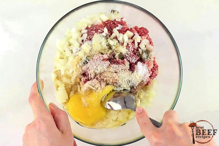 all of the ingredients for swedish meatballs in a glass bowl being mixed with a spoon
