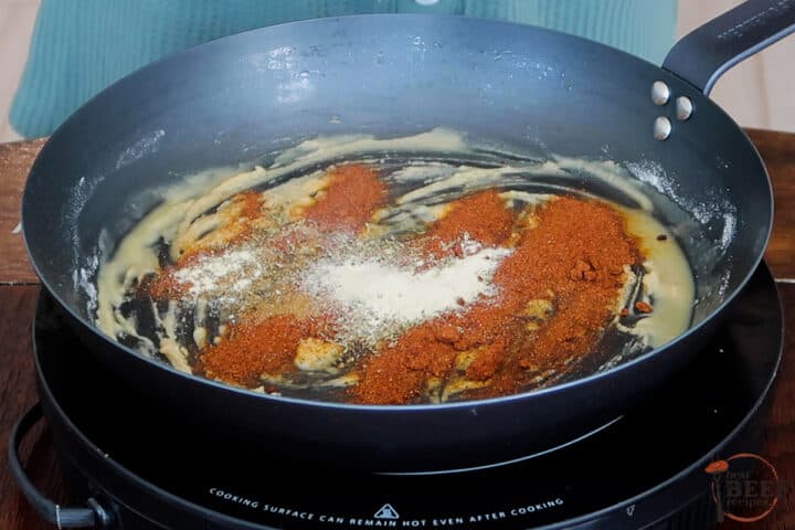 enchilada sauce ingredients in a skillet