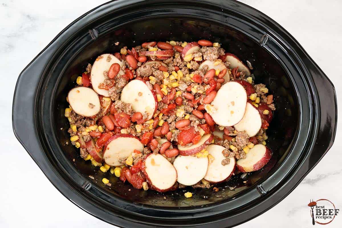 cowboy casserole in the crockpot ready to cook
