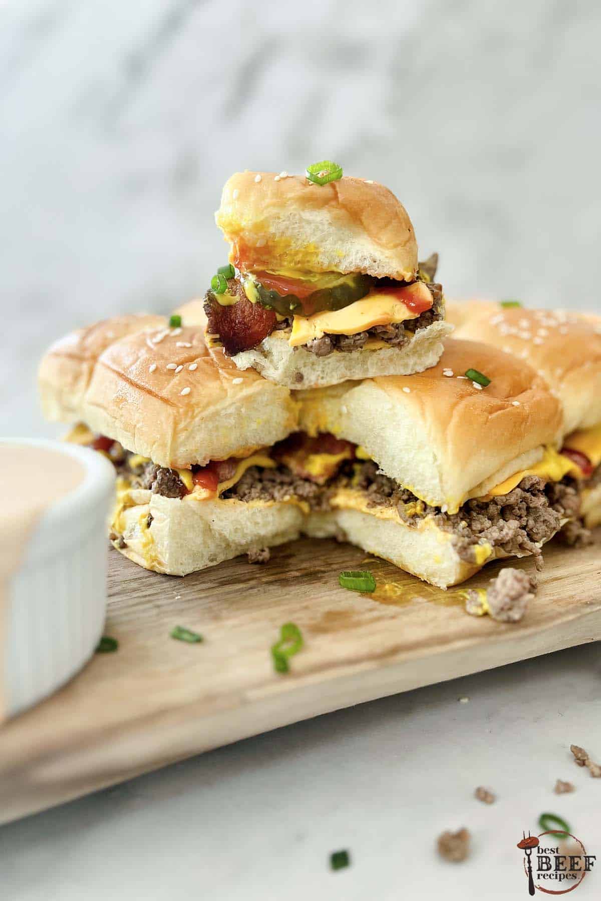 bacon cheeseburger sliders stacked together