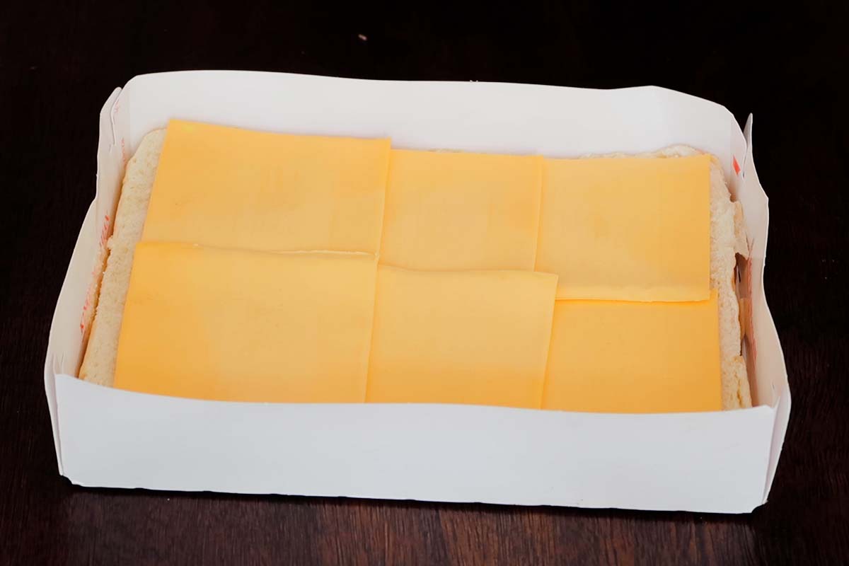 Layering cheese on slider rolls