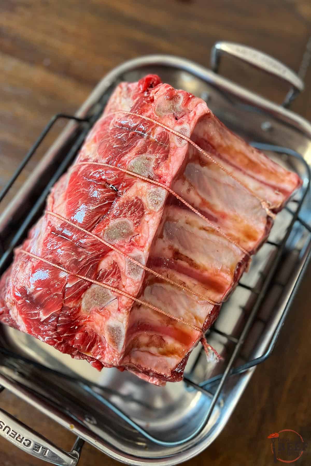 a tied prime rib on a roasting rack