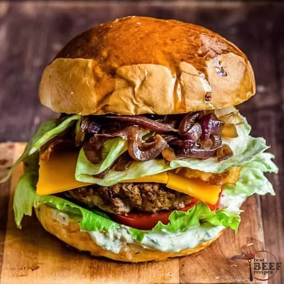 an assembled loaded burger on a cutting board