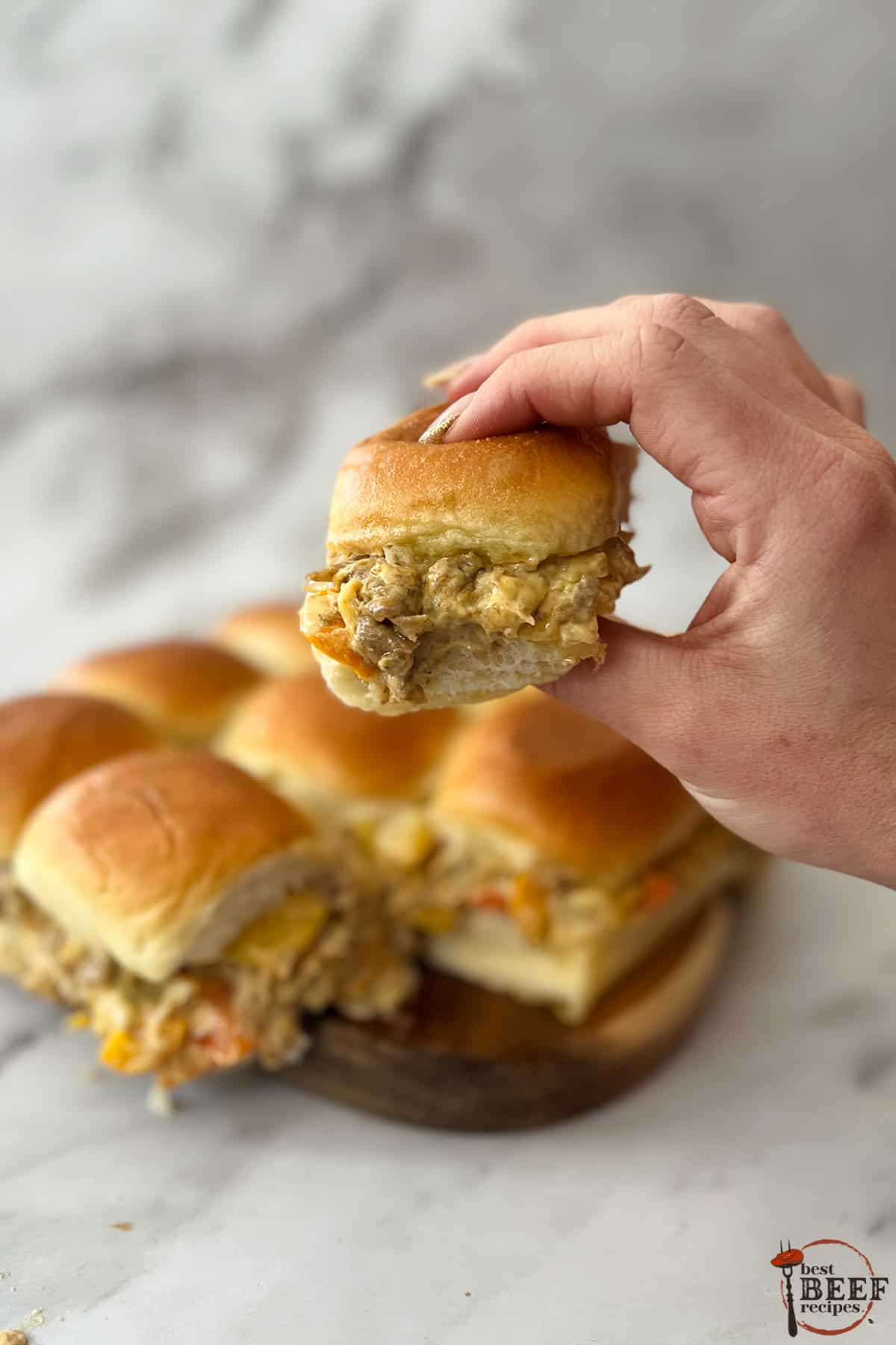 holding philly cheesesteak sliders