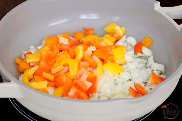 chopped onions and peppers in a skillet