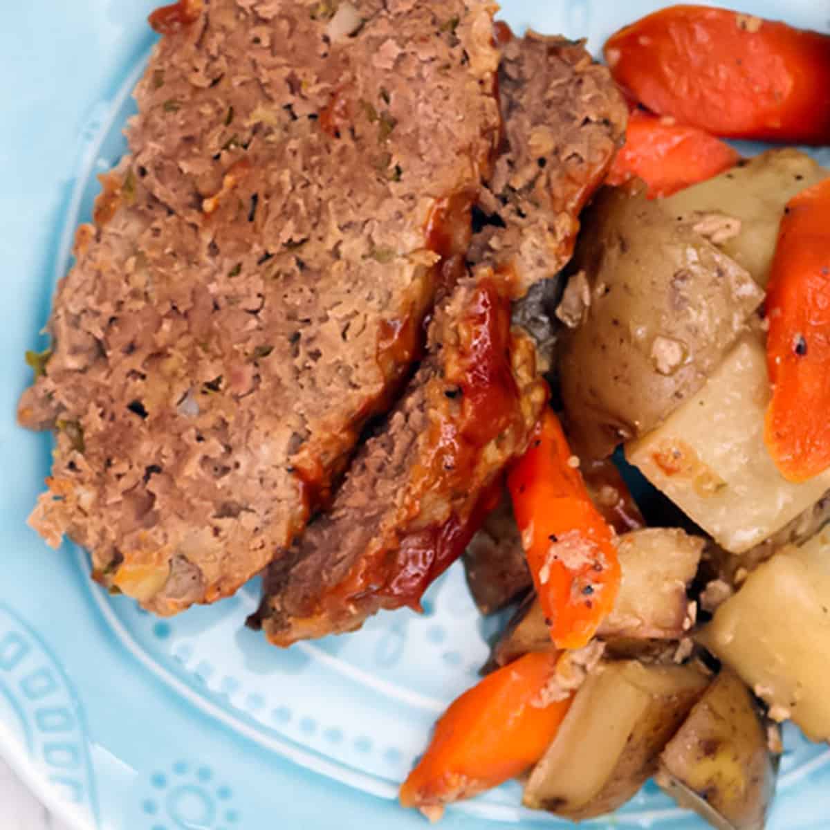 slices of crock pot meatloaf with carrots and potatoes