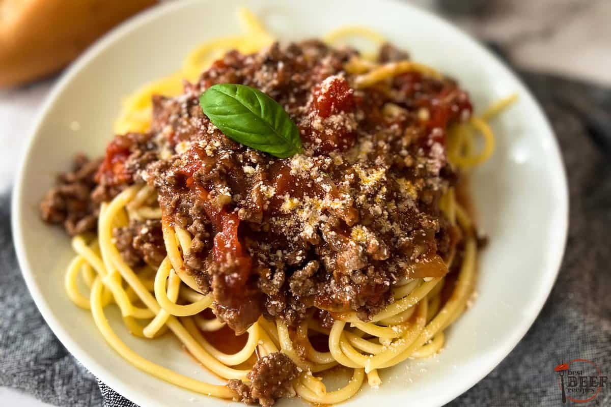 a completed plate of sugo di carne on spaghetti