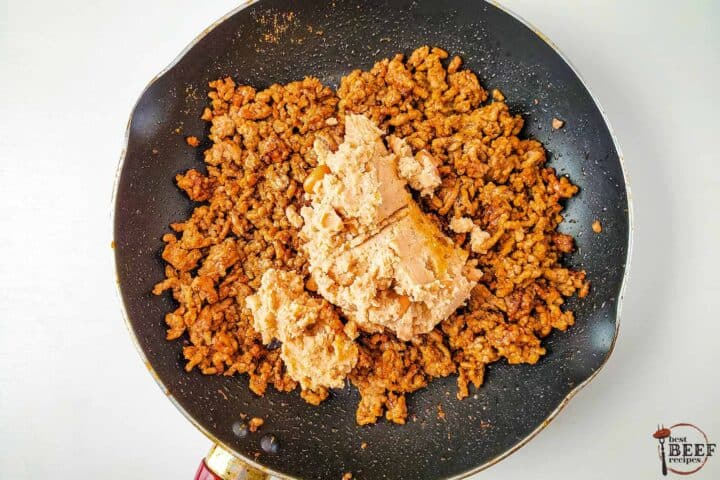 the ground beef with refried beans added to the pan