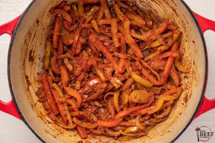 adding the paste and seasonings to the pot with the vegetables