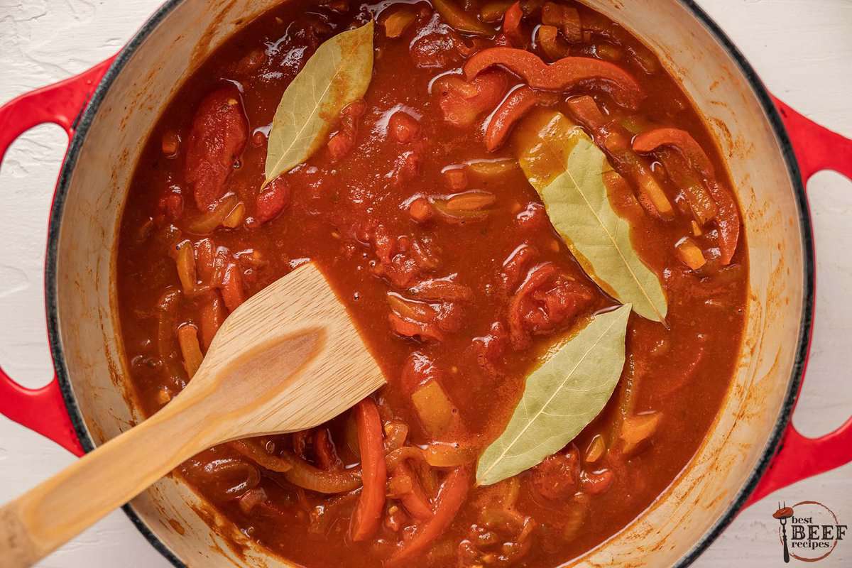 ropa vieja vegetables and broth in a pot with bay leaves