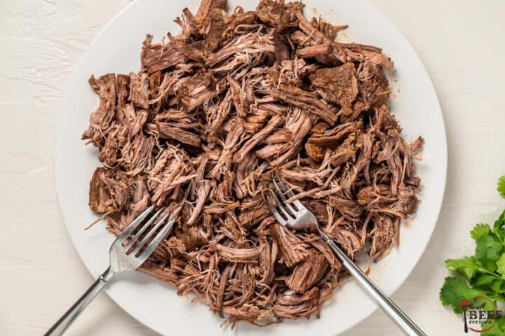 ropa vieja steak on a plate after being shredded