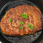 a tenderized grilled steak in a pan