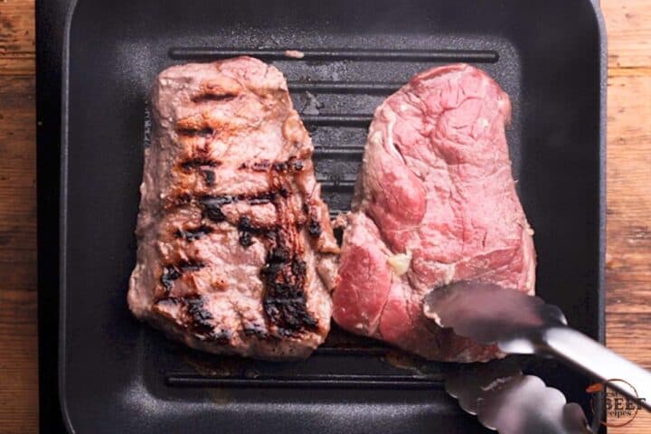 flipping sirloin steaks in a grill pan