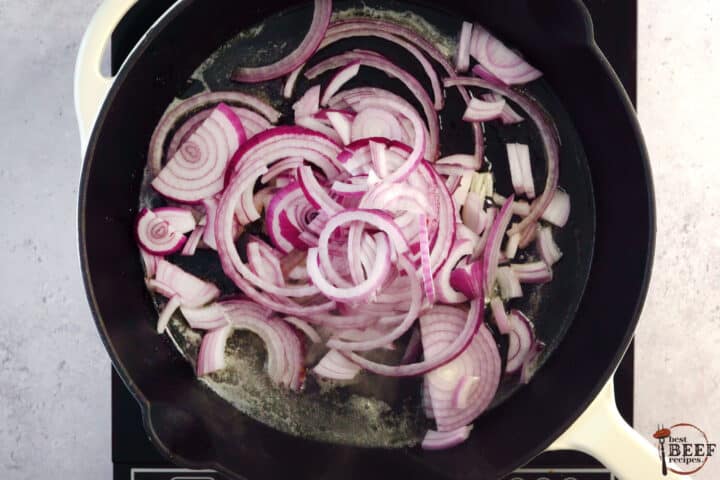 red onions added to a skillet with butter
