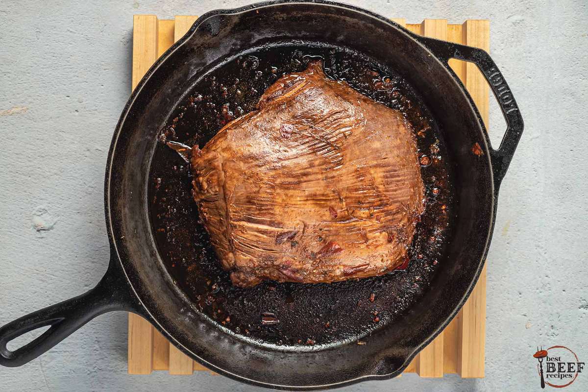 guajillo steak searing on a cast iron pan