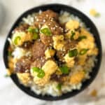 a top view of a bowl of rice and korean meatballs