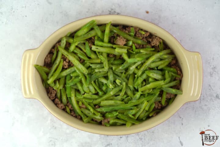 frozen green beans layered over a casserole dish