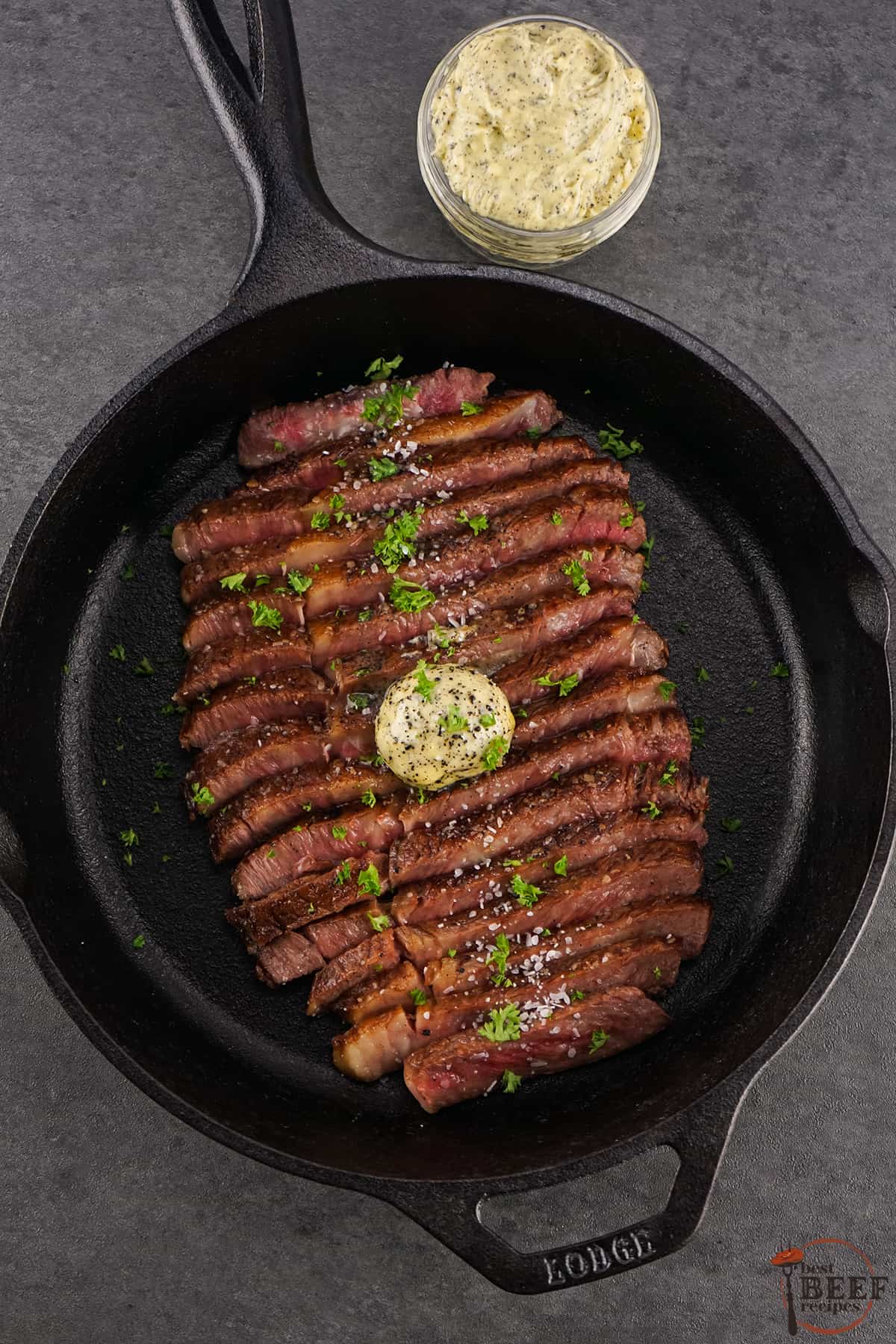 wagyu steak in a frying pan with truffle butter, sliced