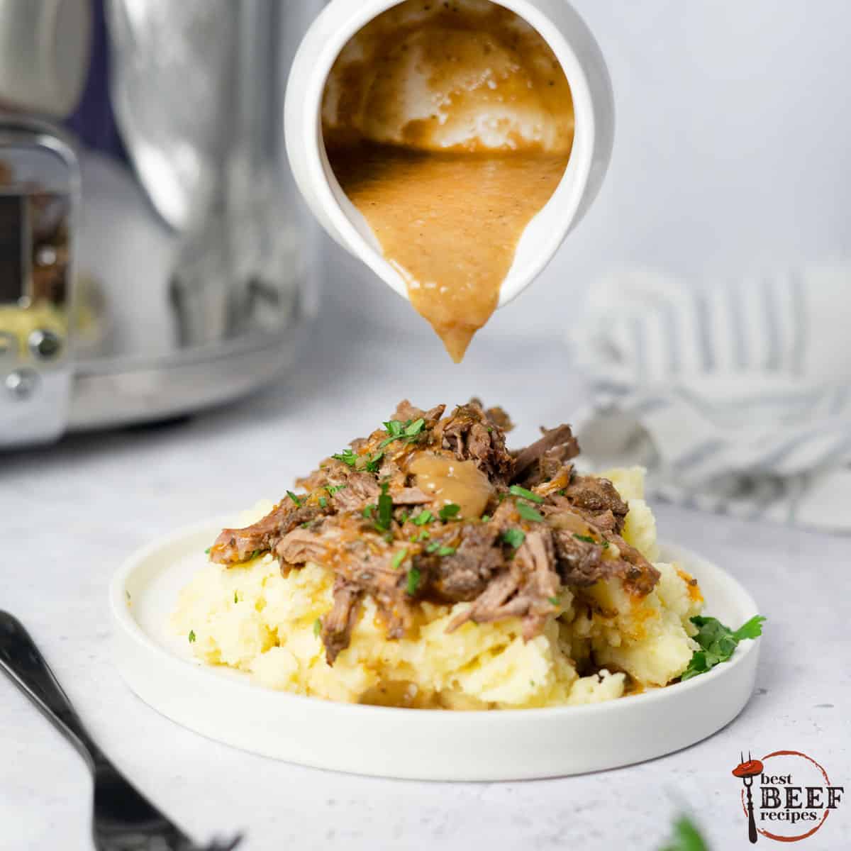 beef gravy pouring over chuck roast