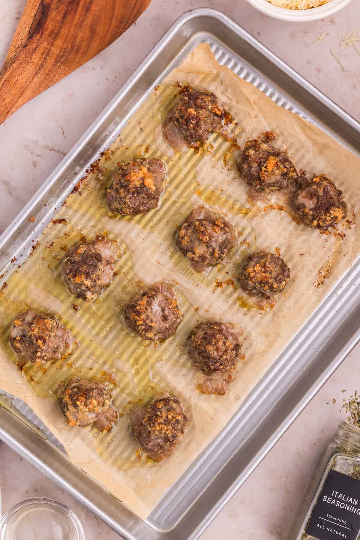 broiled meatballs for soup on a baking sheet