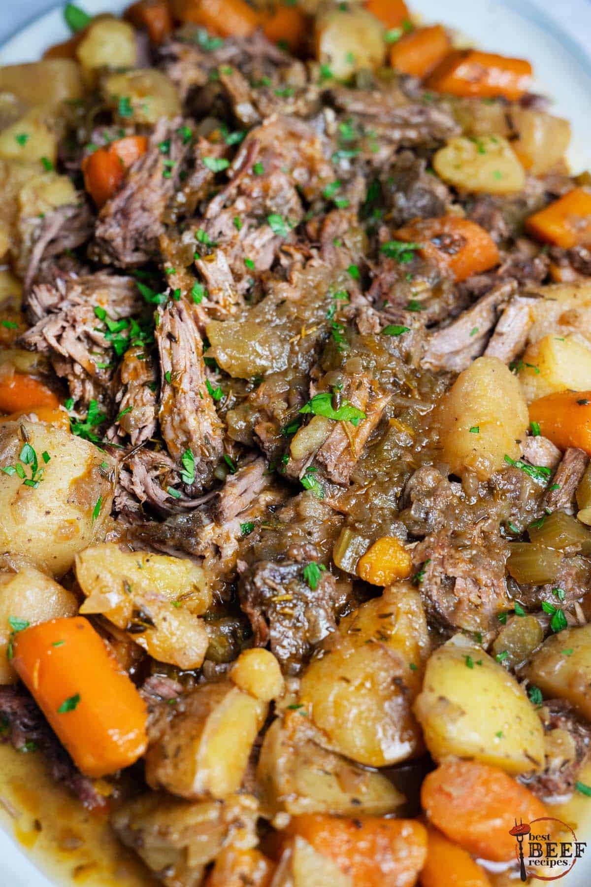 slow cooker roast beef shredded over potatoes and carrots