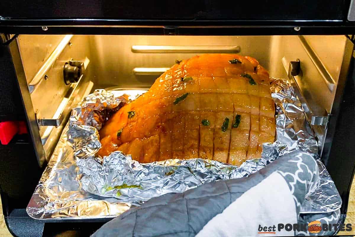 placing unwrapped ham in air fryer to sear