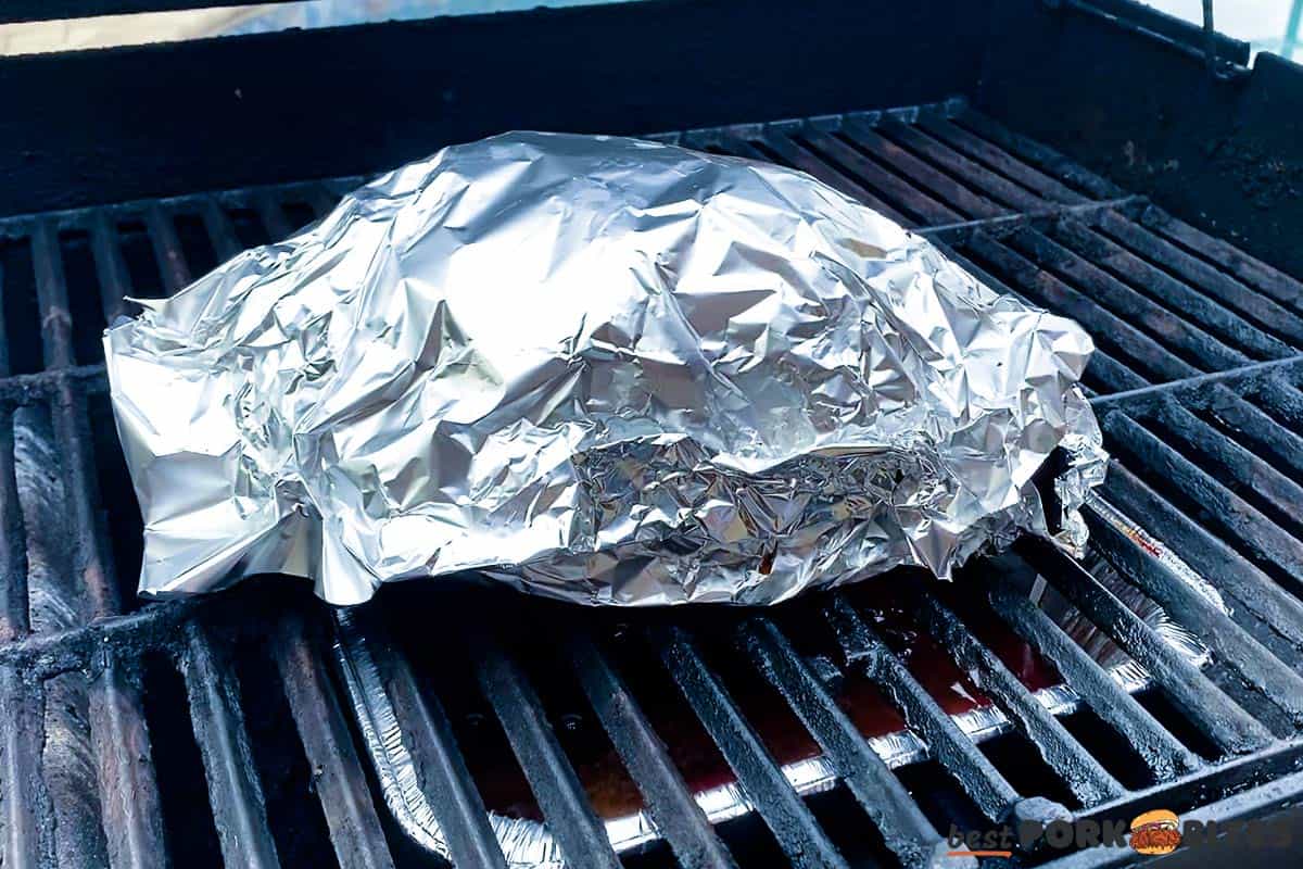 boston butt wrapped in foil on grill