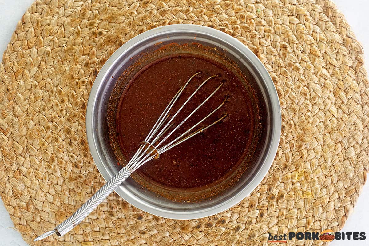 bbq sauce in a bowl with a whisk