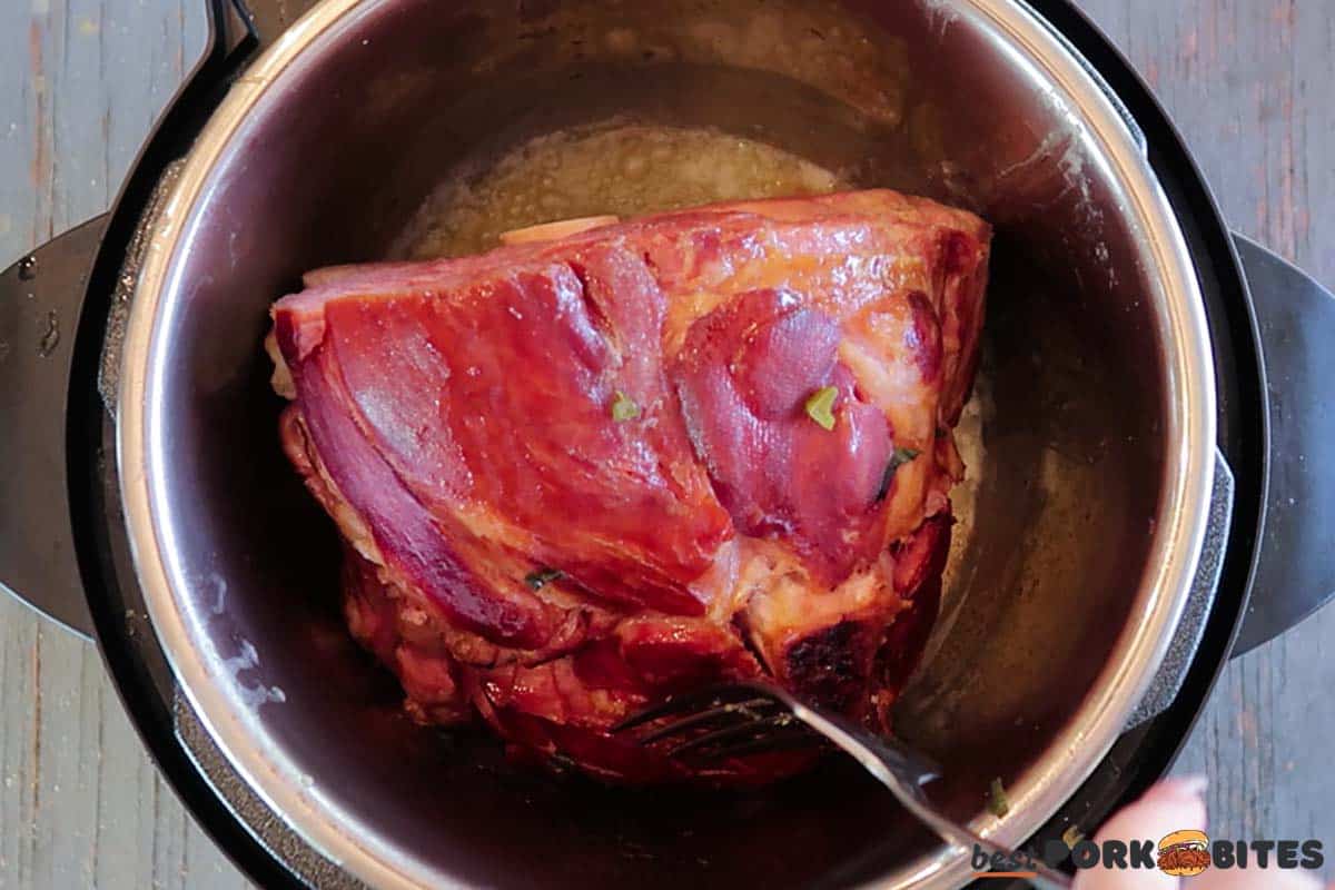 partially cooked ham being seared in the instant pot