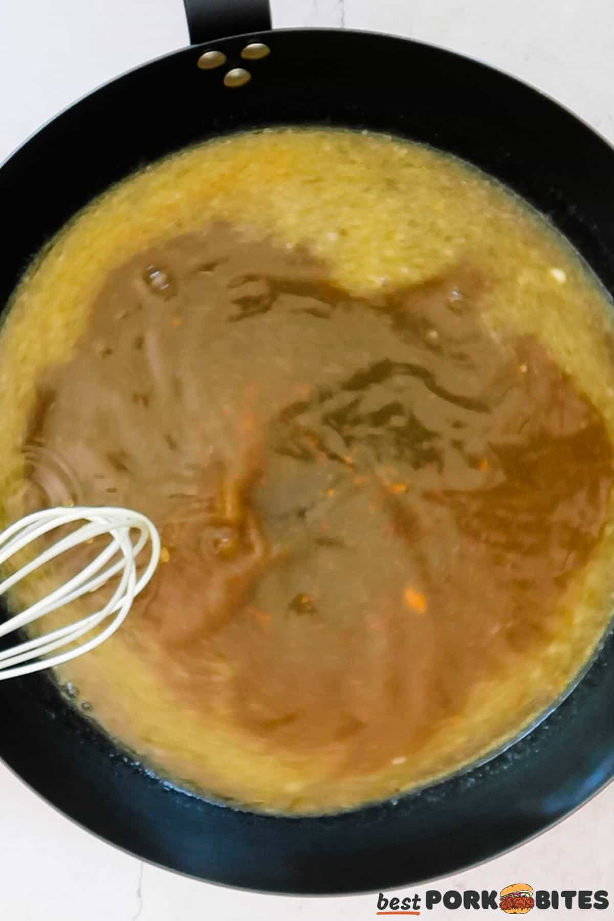 a pan of gravy ingredients with a whisk to stir