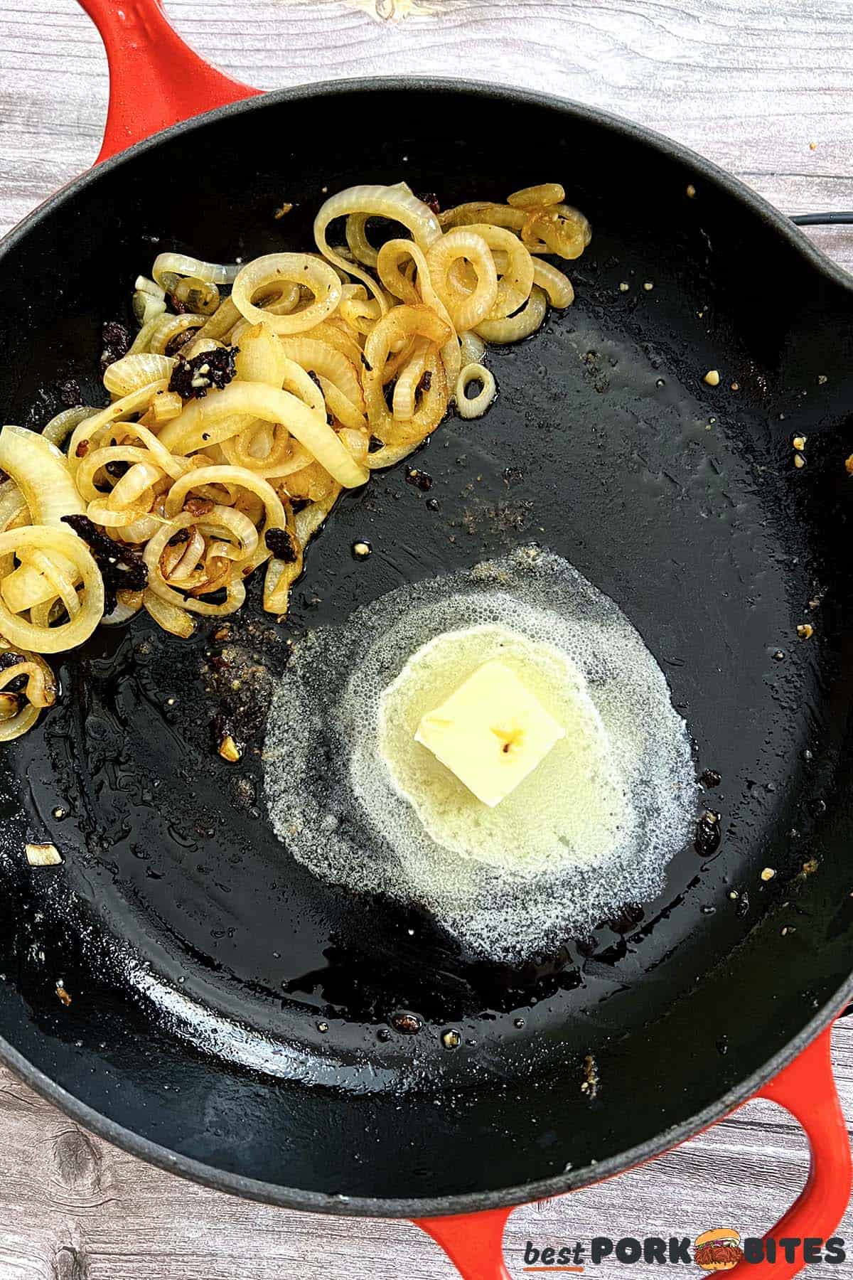 onions and garlic pushed to the side with butter melting in a pan