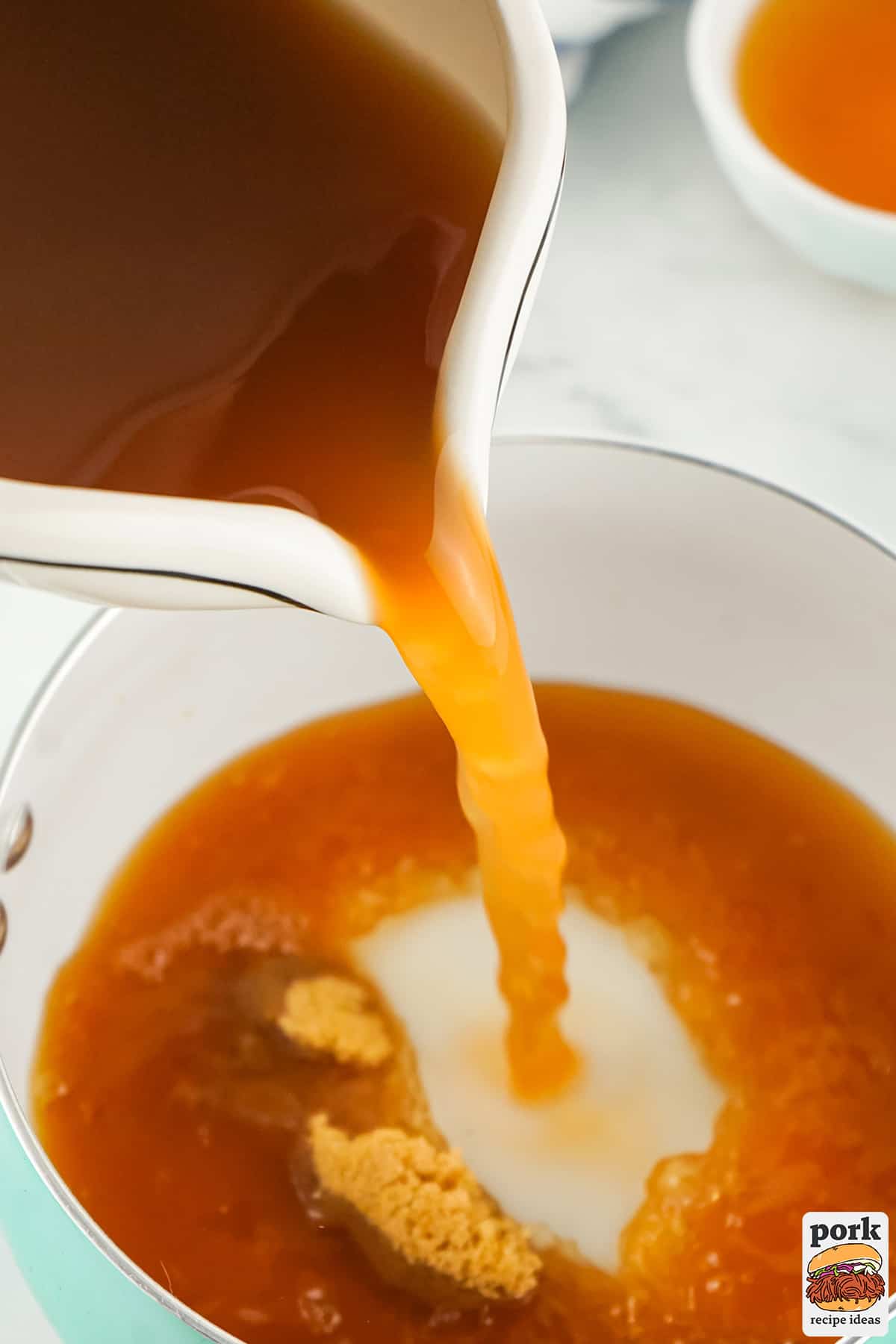 apple cider vinegar being poured into a saucepan