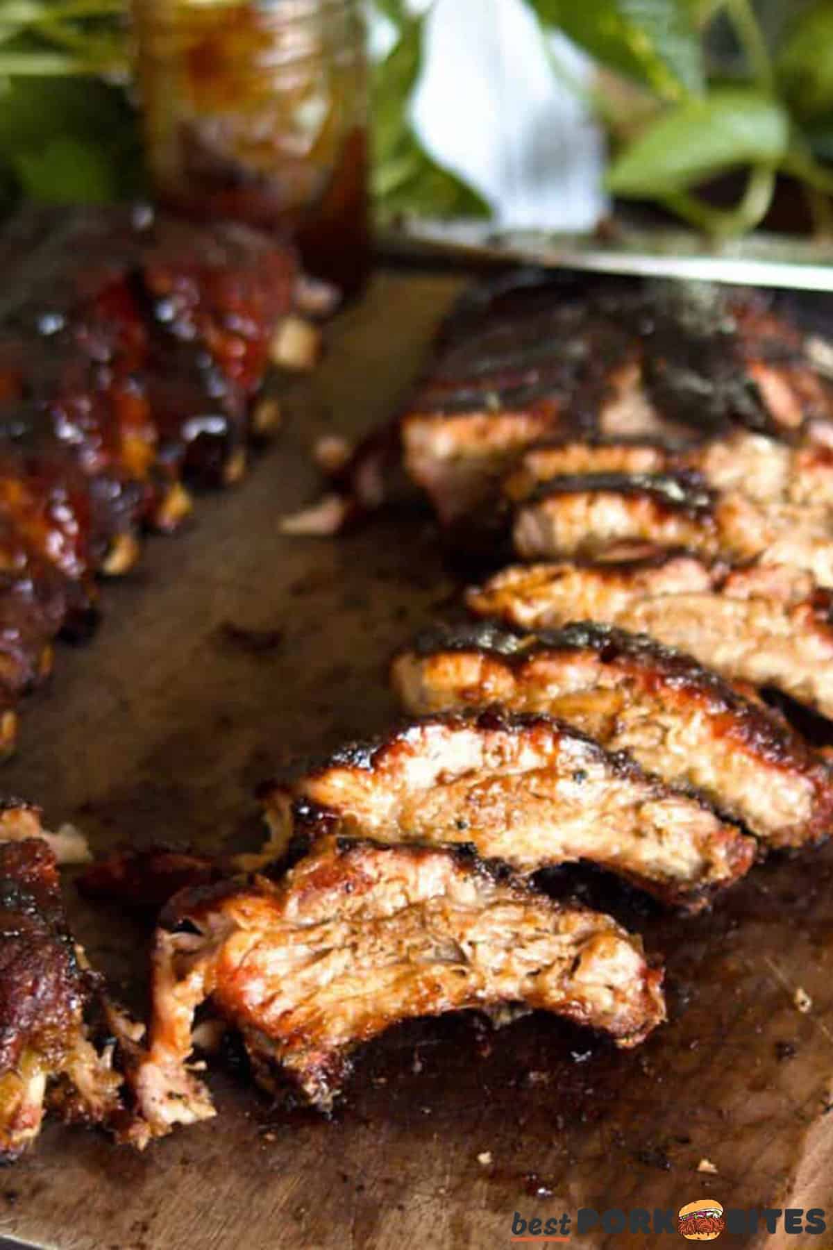 sliced baby back pork ribs on a cutting board