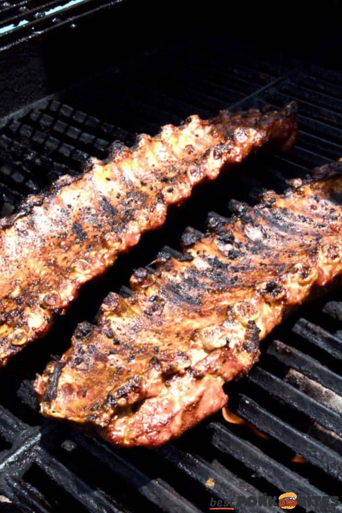 pork ribs being barbecued on a grill