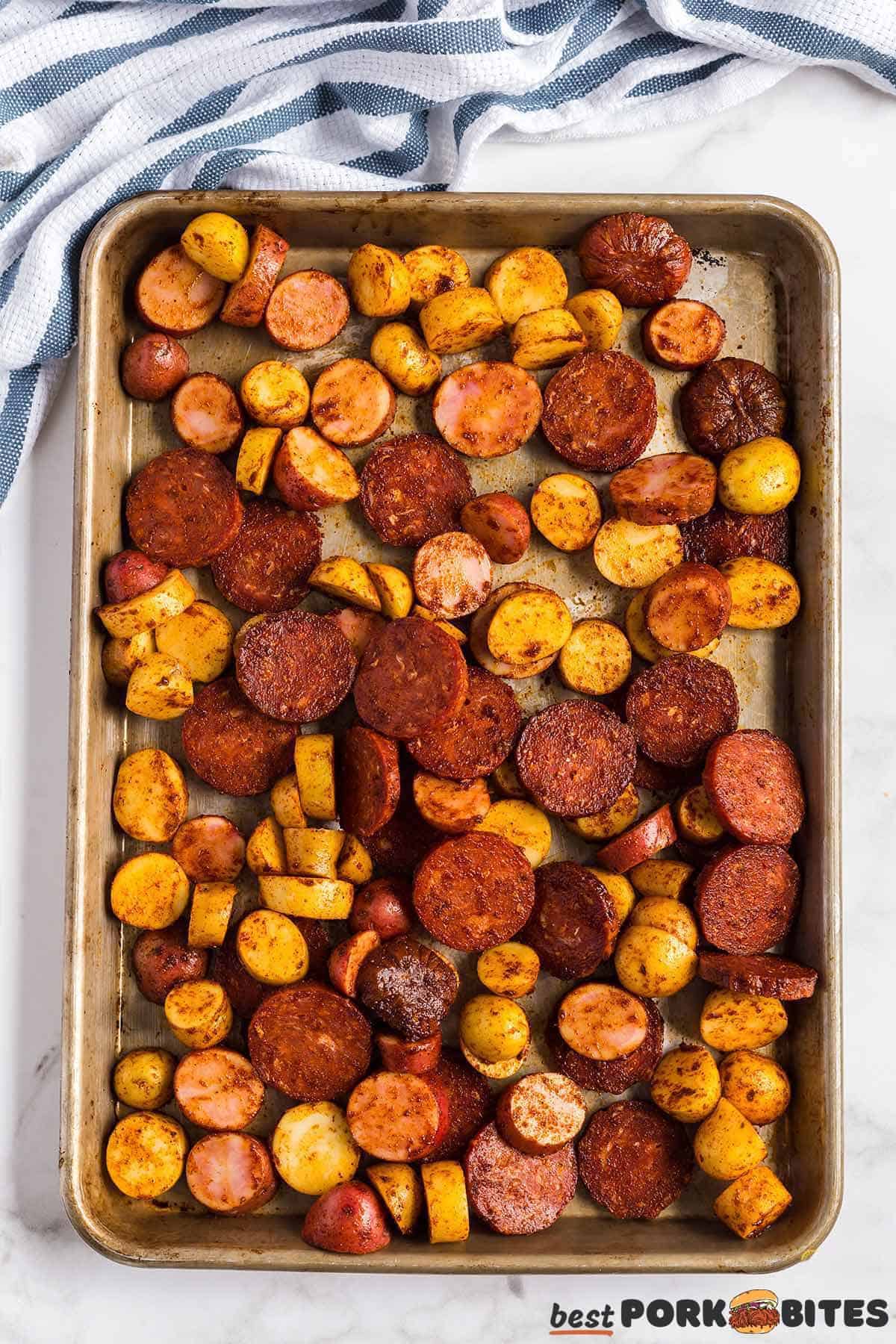 a sheet pan filled with baked chorizo and potatoes